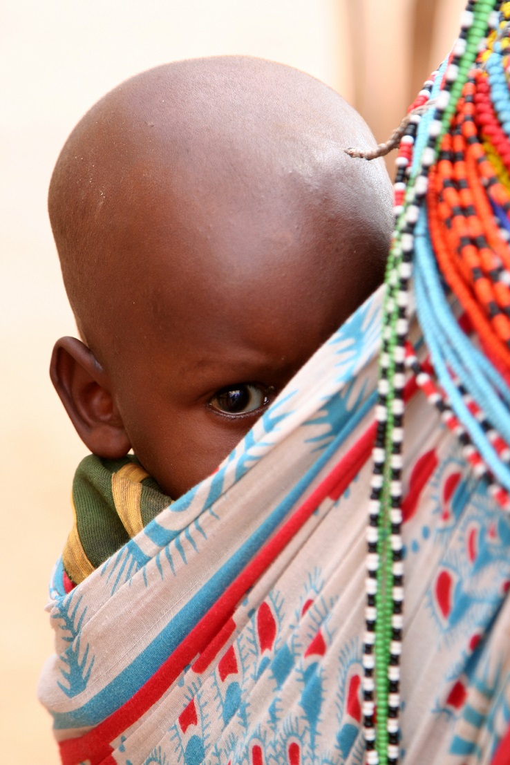 Kenyan baby carried by mother