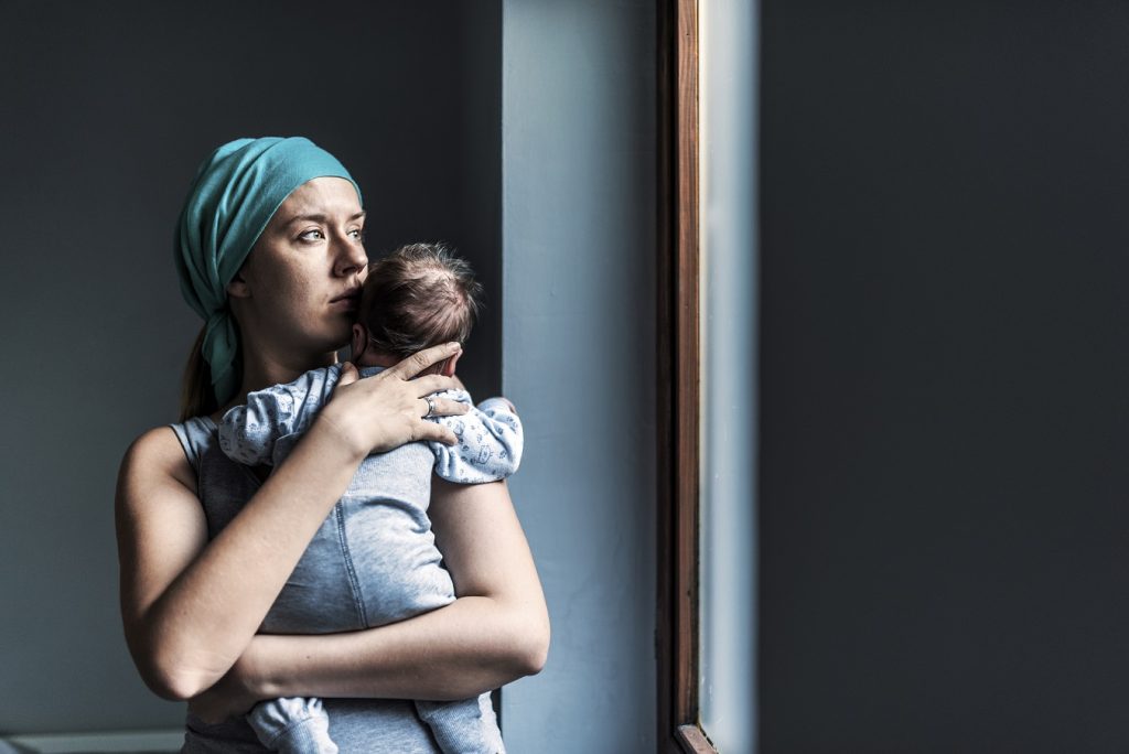 thoughtful mother holding baby