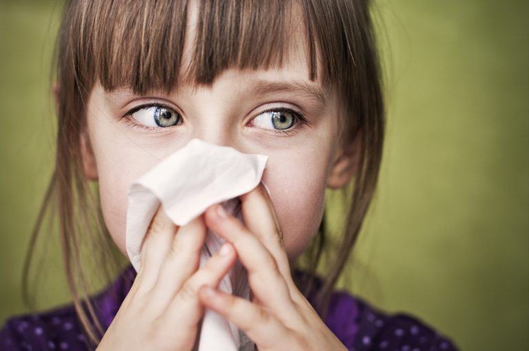 girl blowing her nose