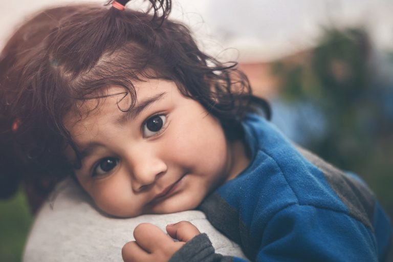 little girl on mother's shoulder