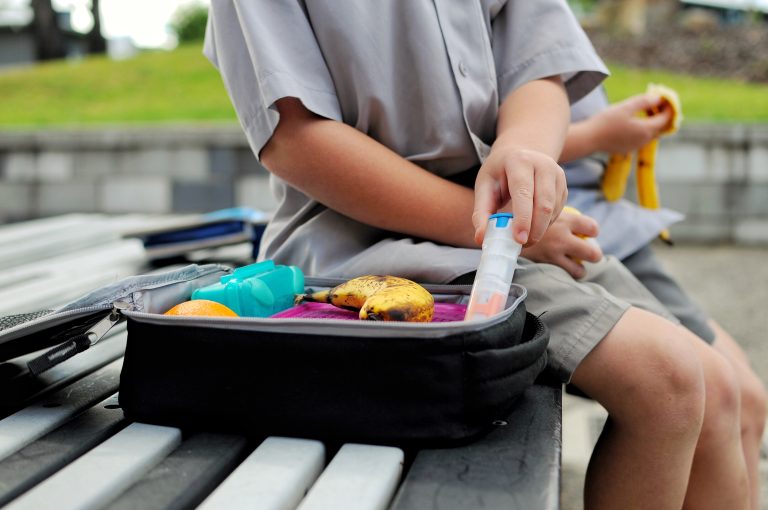 young boy and his EpiPen kit