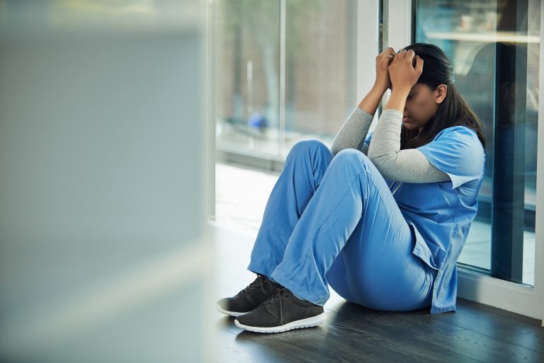 distraught doctor sitting on the floor