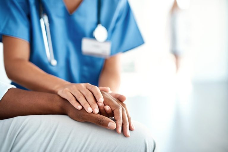 doctor holding patient's hand