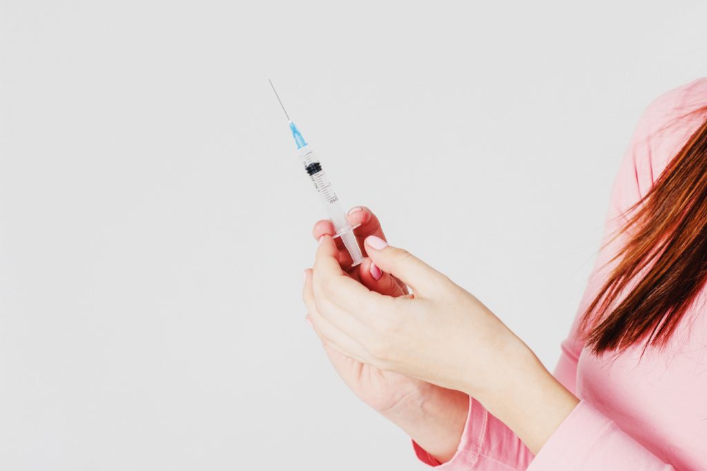 woman holding a syringe