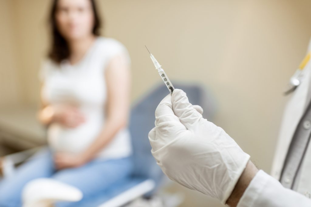 pregnant woman and syringe