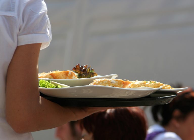 waitress carrying a tray of food