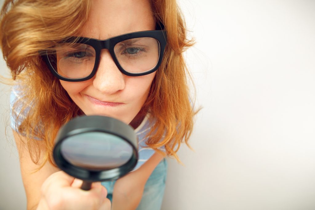 girl looking through looking glass