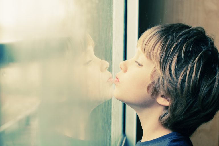 boy looking out window