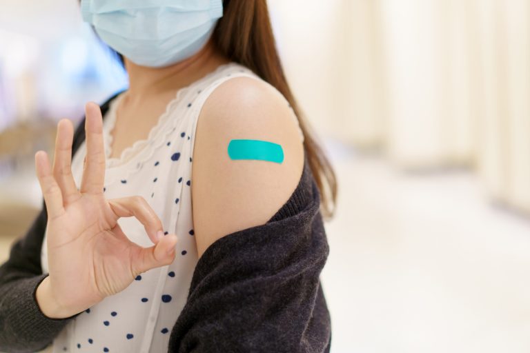 vaccinated girl giving ok sign