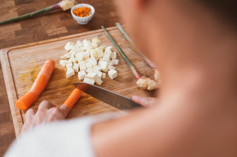 woman cutting carrot