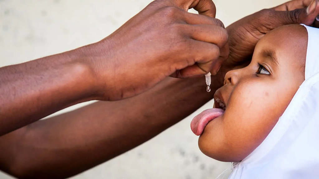 African girl receiving oral polio vaccine